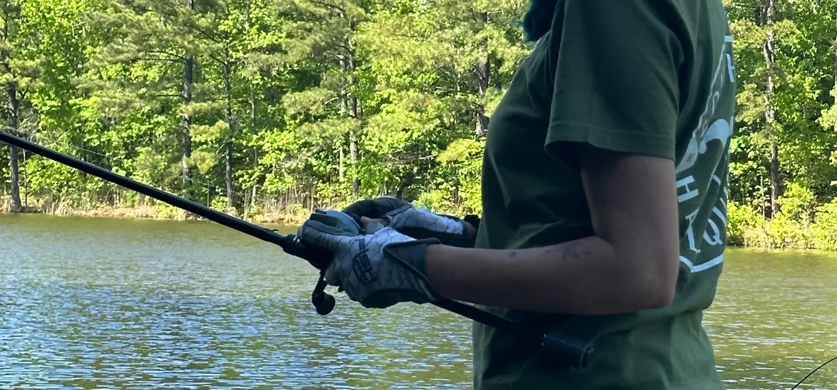 Gina mid-cast fishing on an NC lake