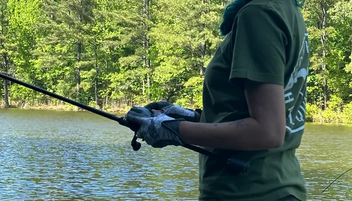 Gina mid-cast fishing on an NC lake