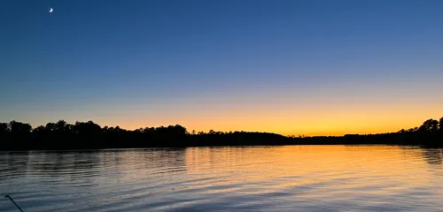 Dusk over an NC lake with a crescent moon