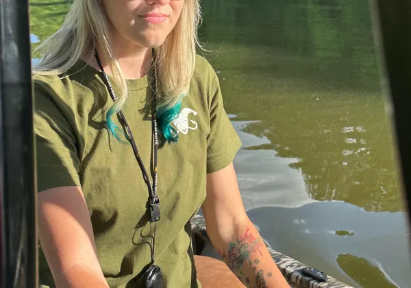 Gina at the helm of her boat on an NC lake