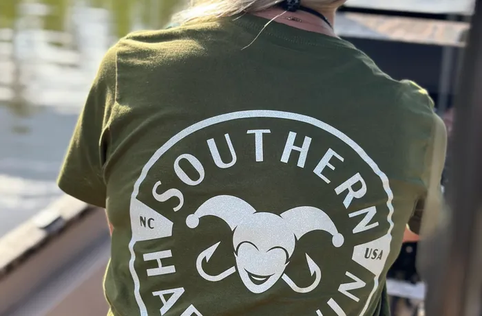 Gina wearing the Southern Harlequin logo tee on the lake