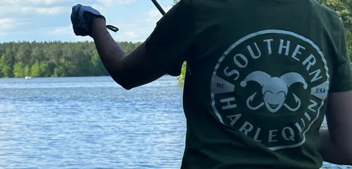 Casting into open water under a wide blue sky on an NC lake
