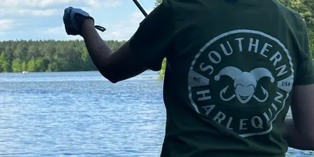 Casting into open water under a wide blue sky on an NC lake