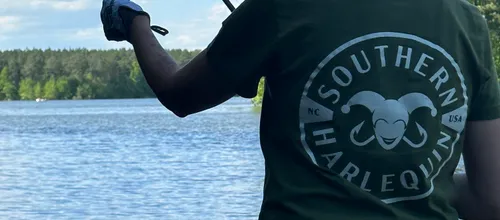 Casting into open water under a wide blue sky on an NC lake